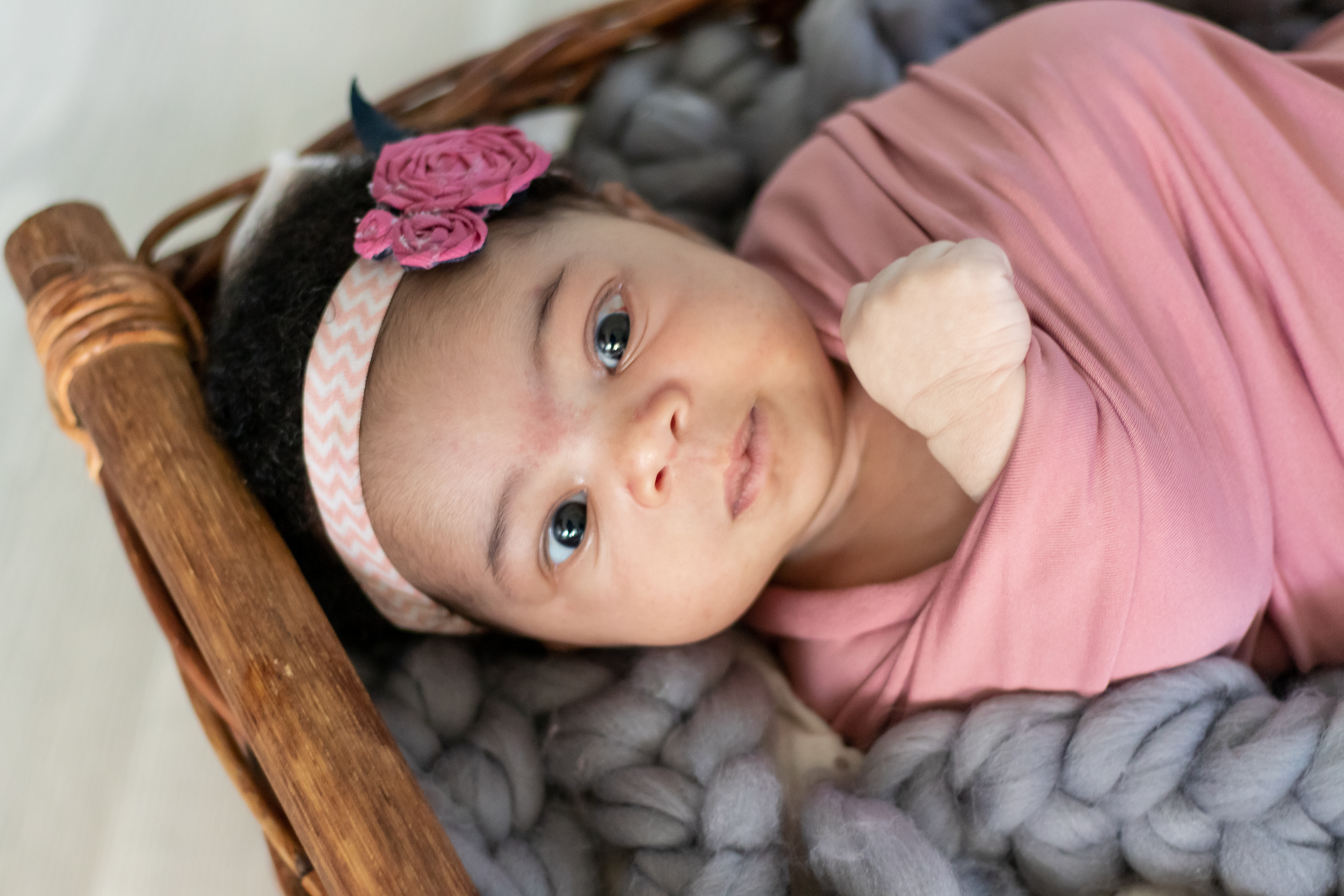 Newborn baby girl wrapped in pink in basket, newborn photographer in Creede