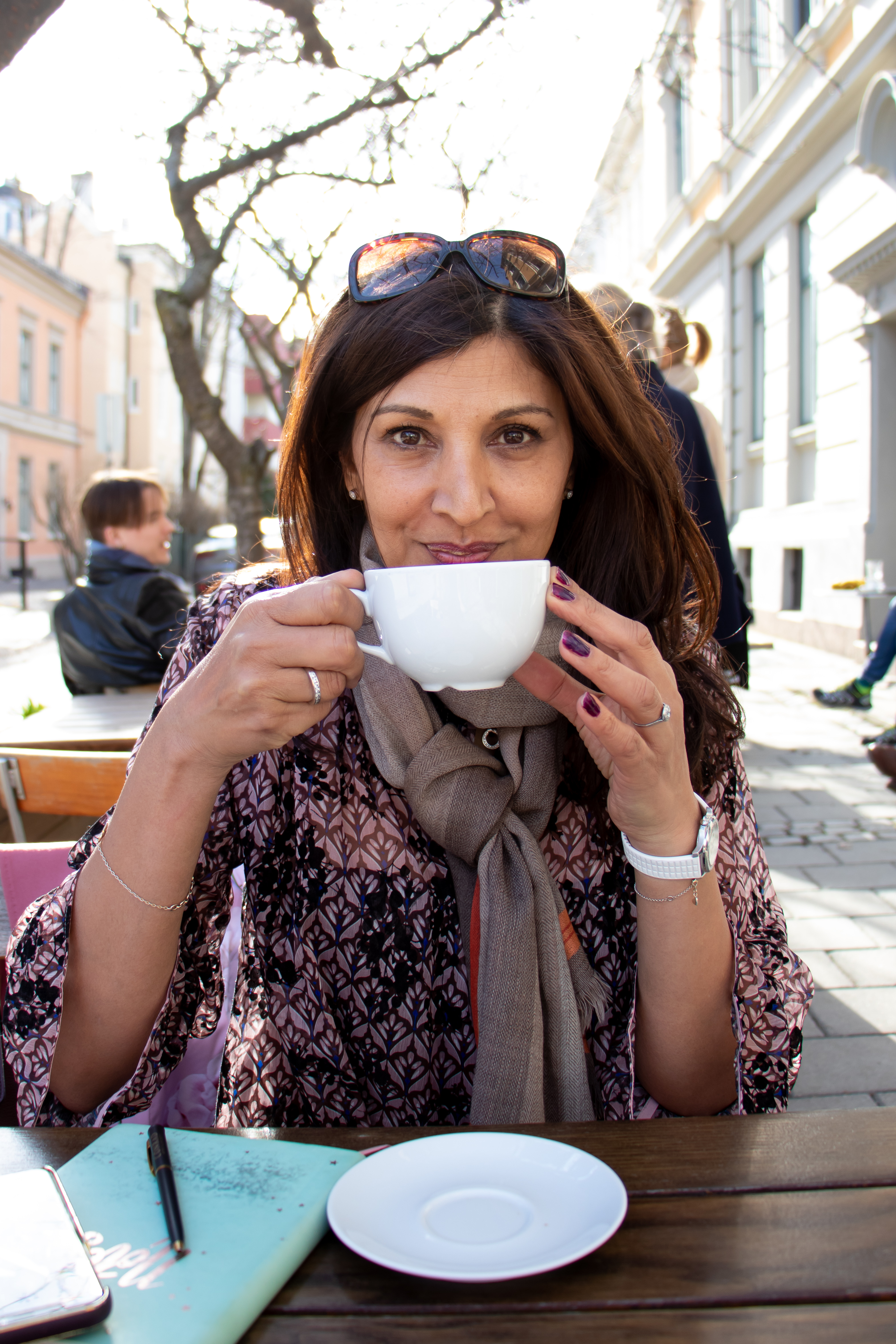 Branding photographer in Colorado, woman drinking coffee in European coffee shop