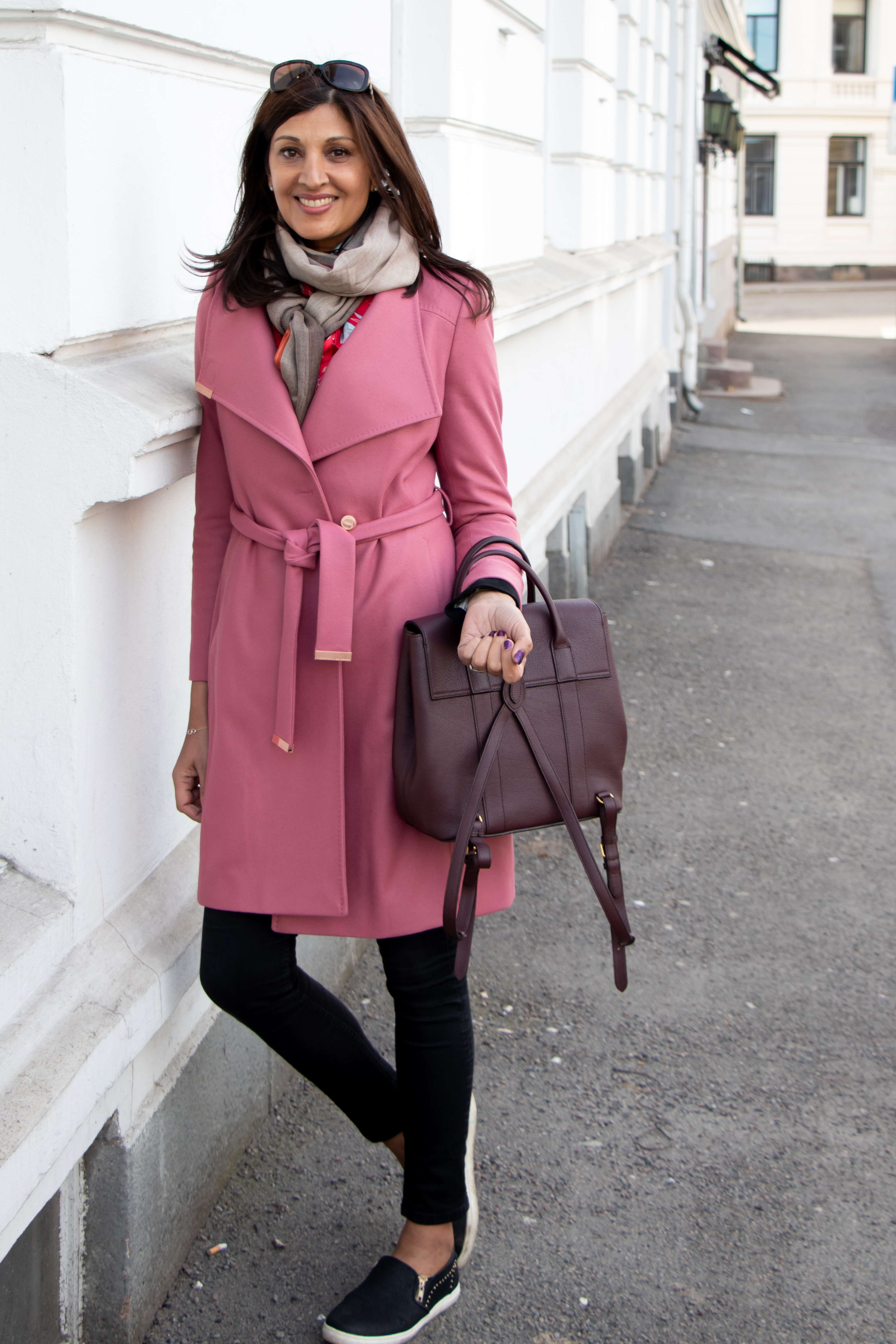 Woman leaning against building in branding photography session in Colorado