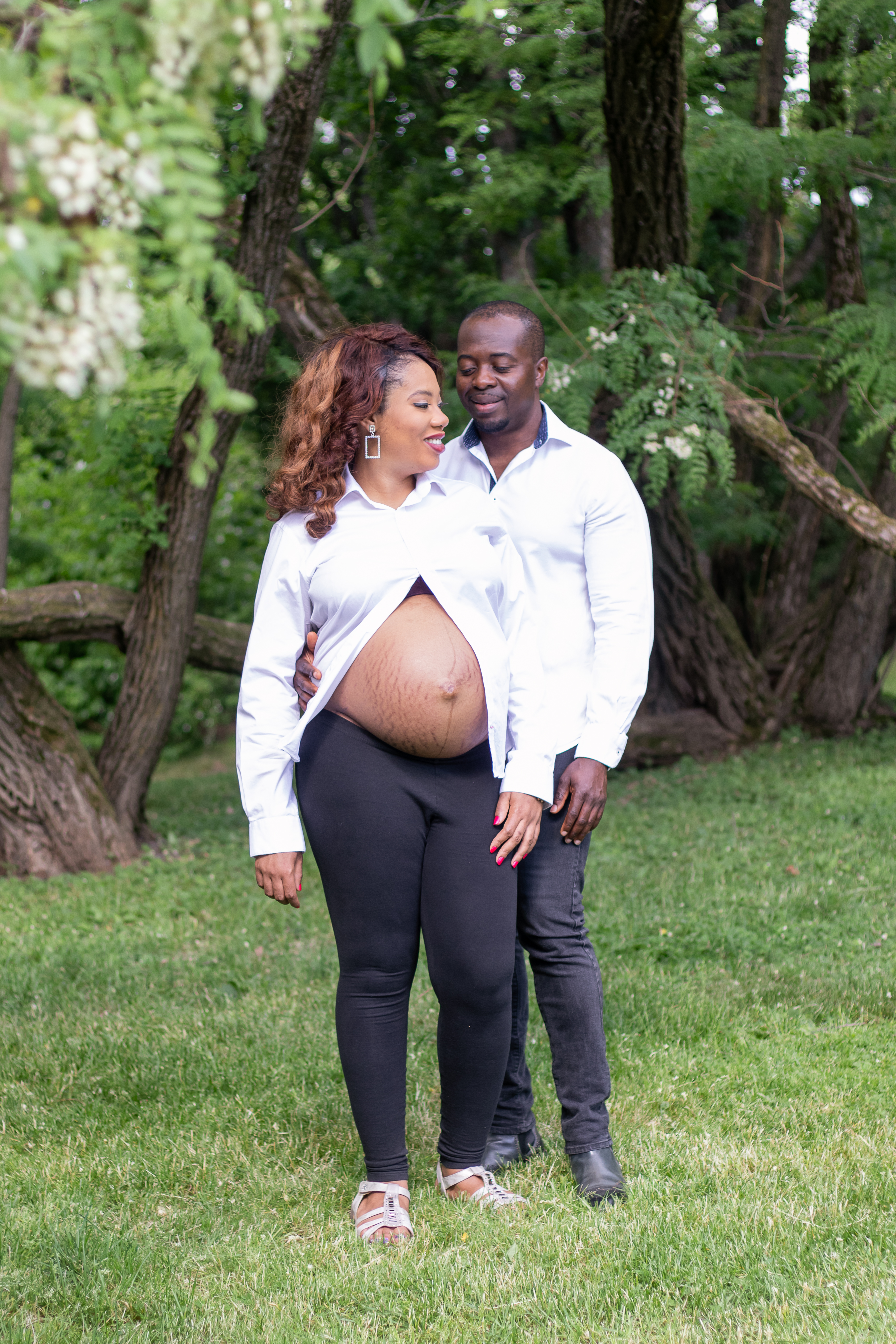 Maternity photo, couples standing among trees, photographer in Creede Colorado