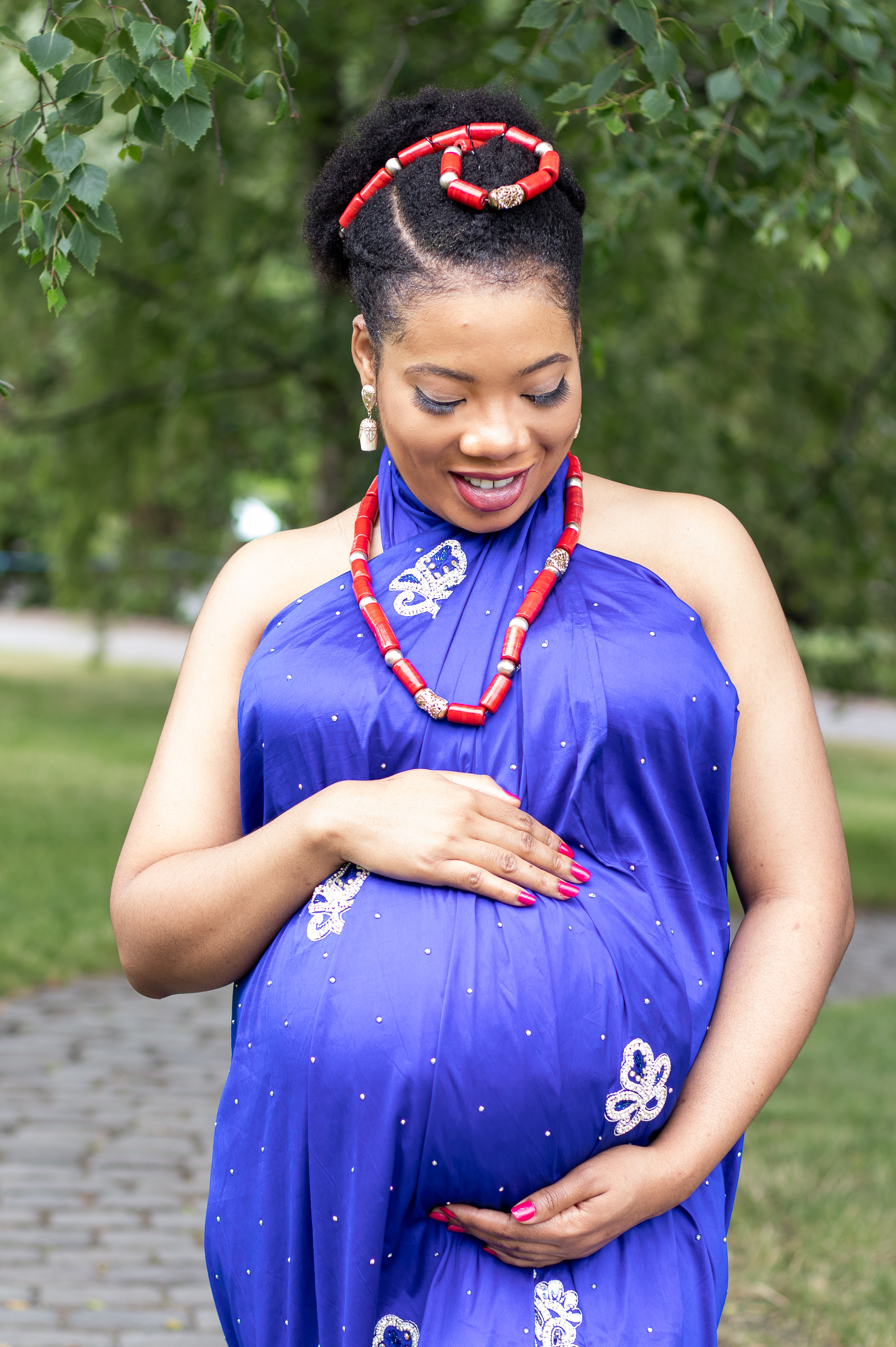 Pregnant woman holding belly, motherhood photographer near me