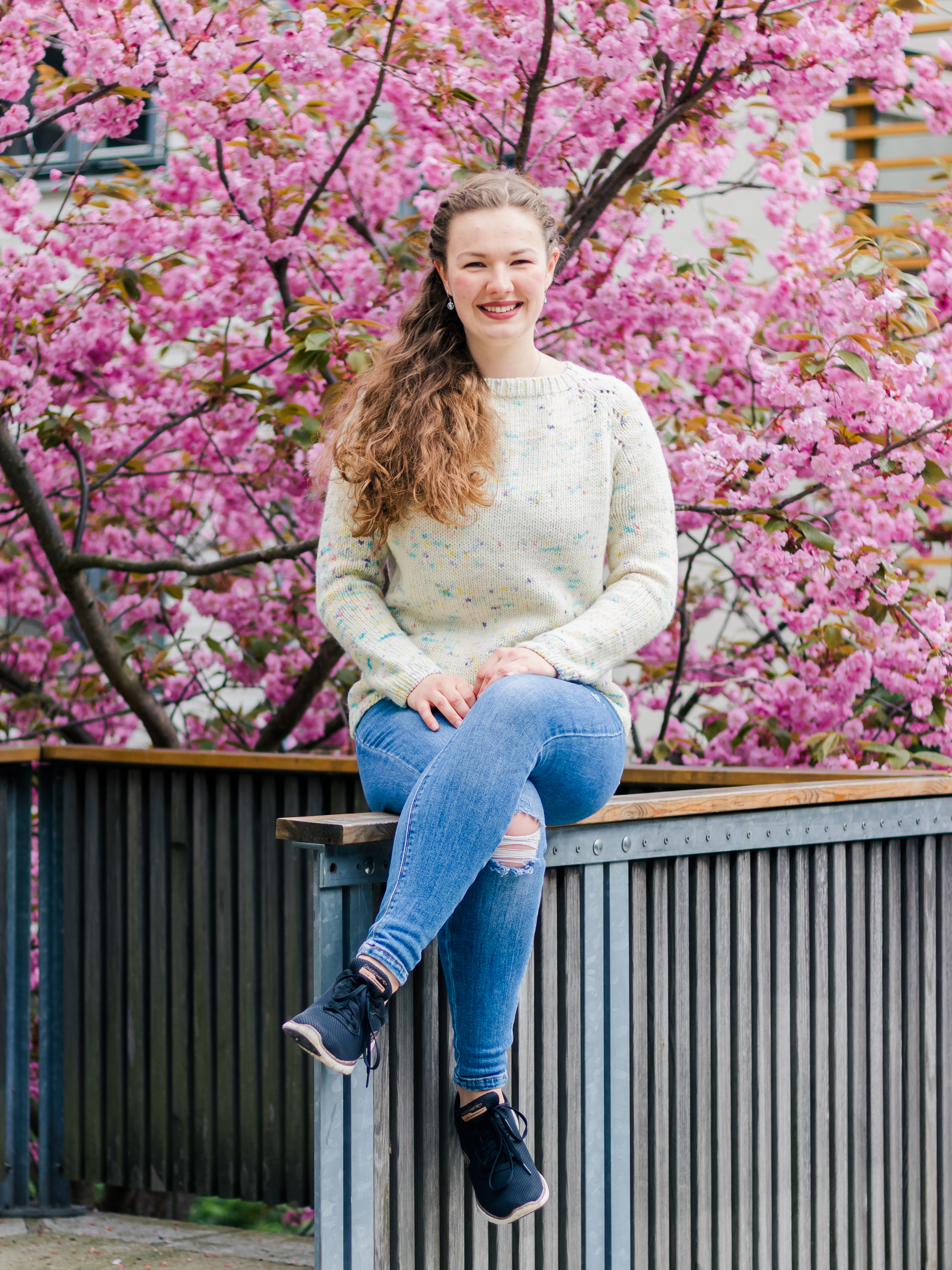 Headshot of woman in front of tree