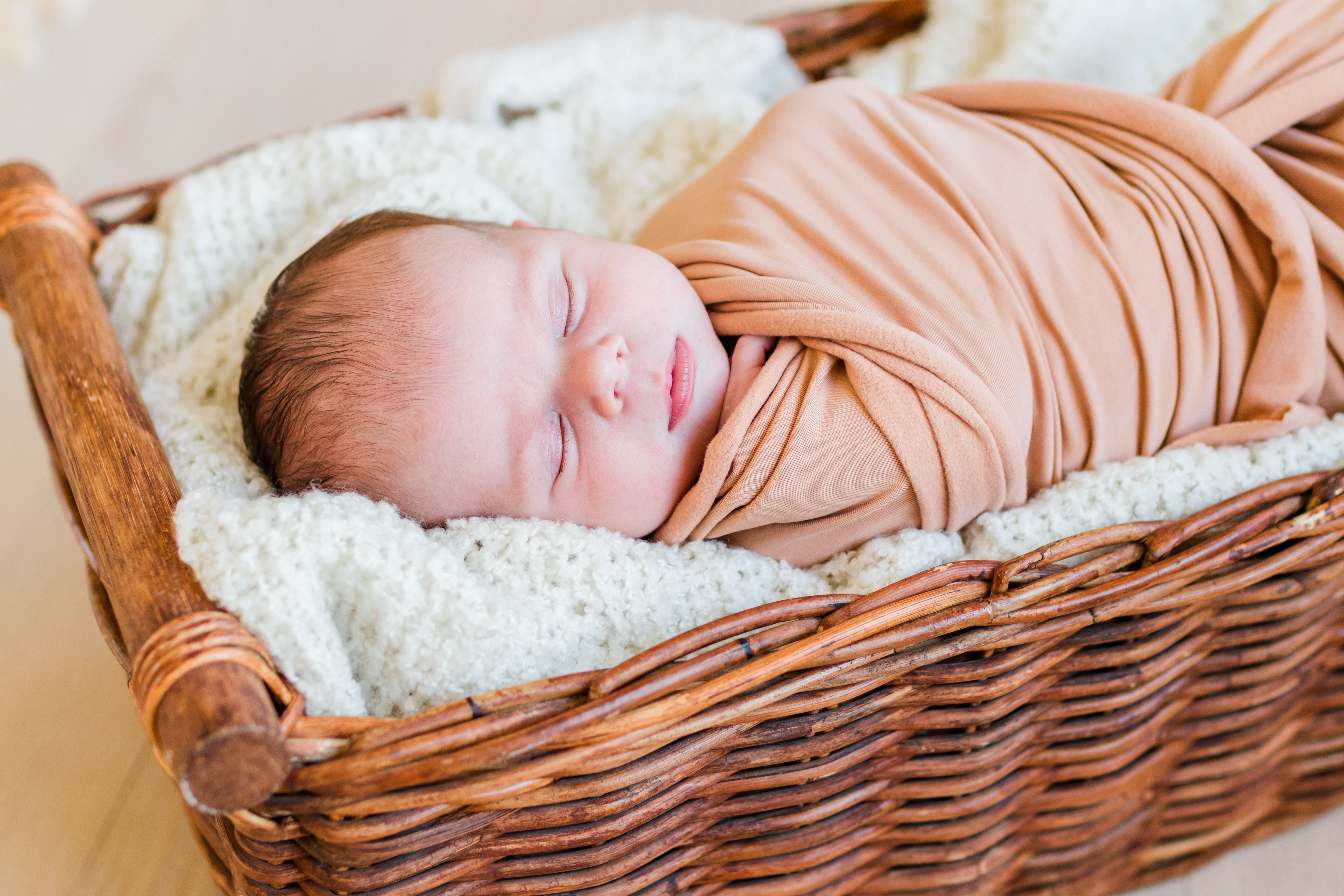 newborn baby swaddled and left in basket