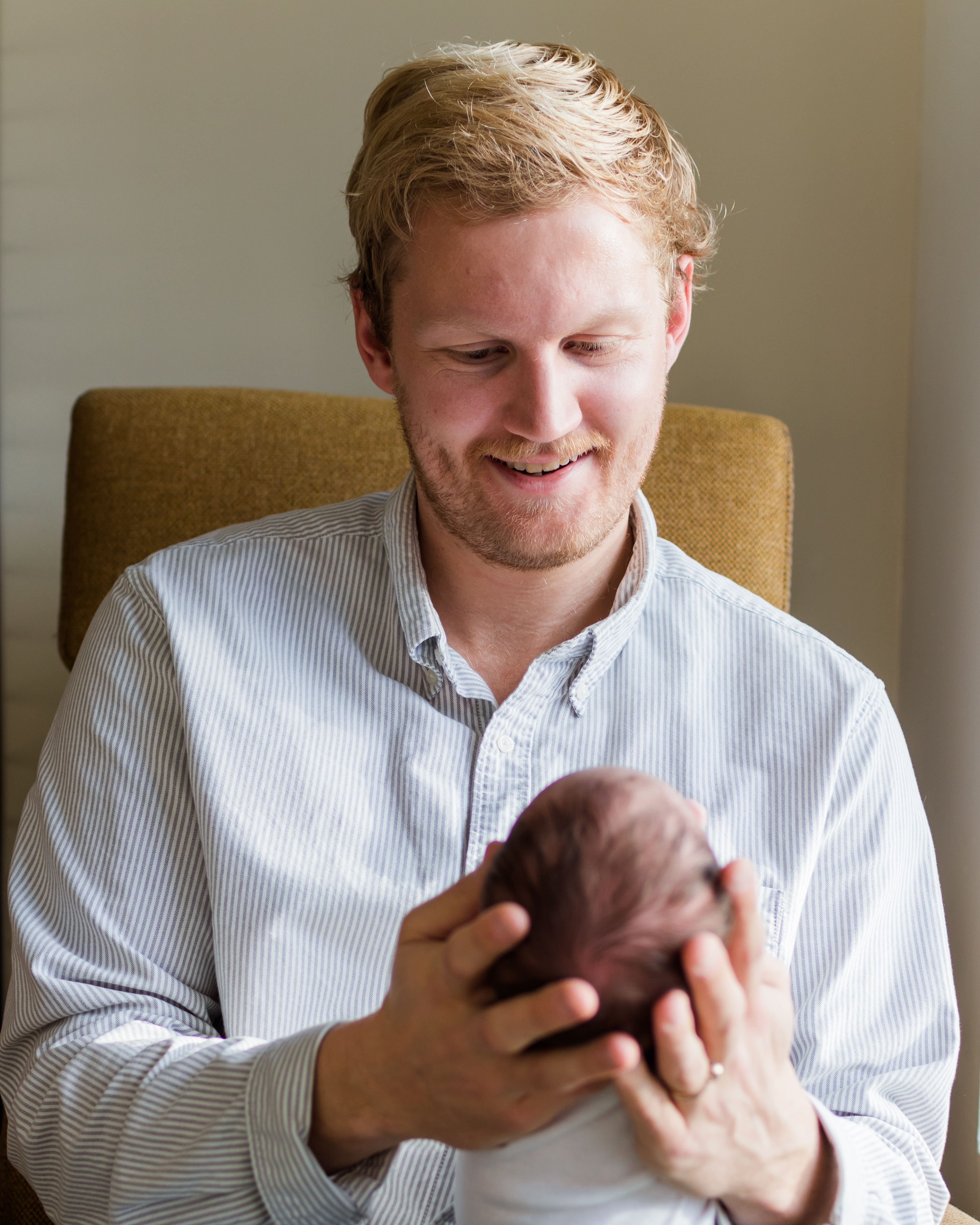 Dad smiling at baby in his hands