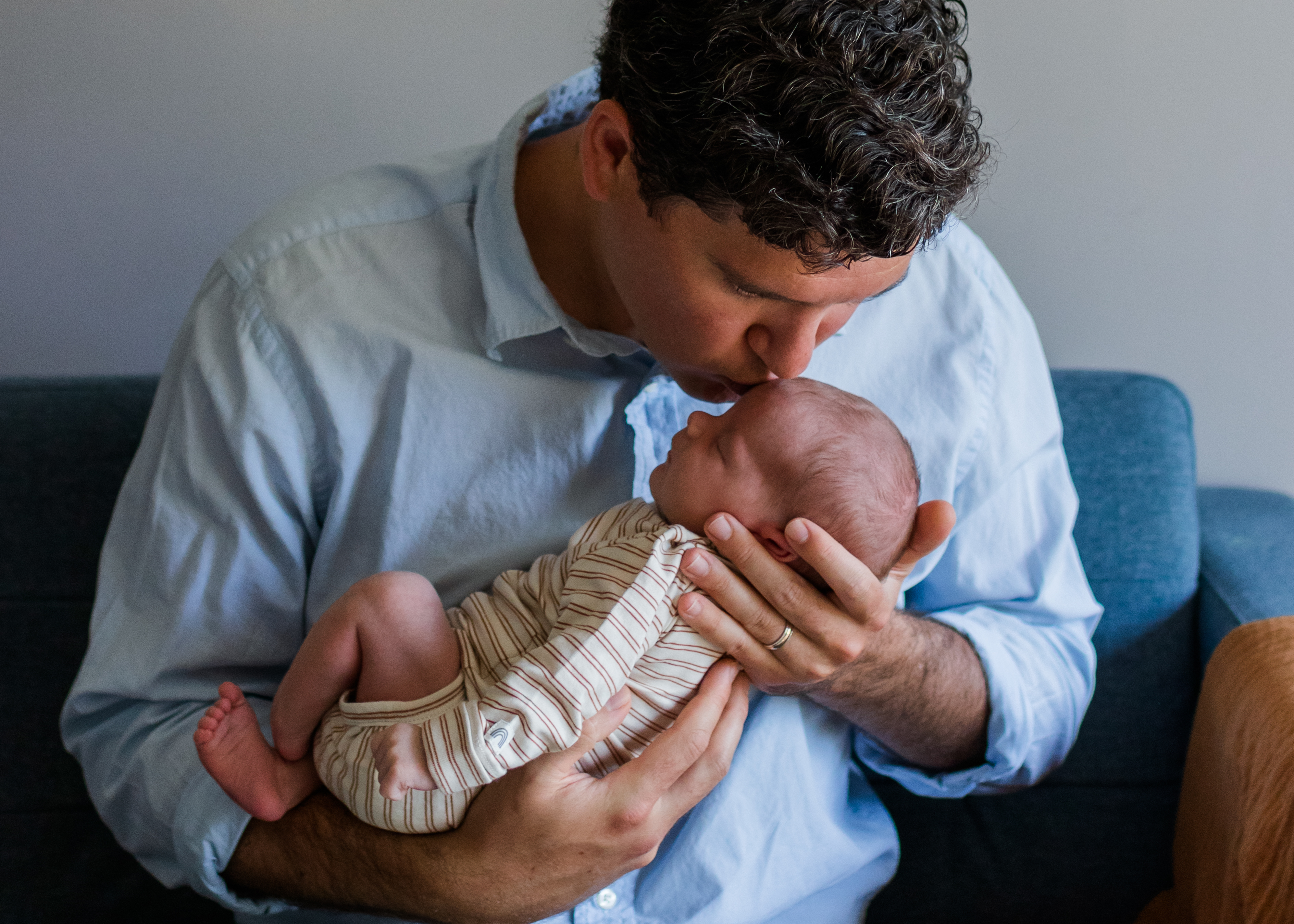 Dad kissing newborn