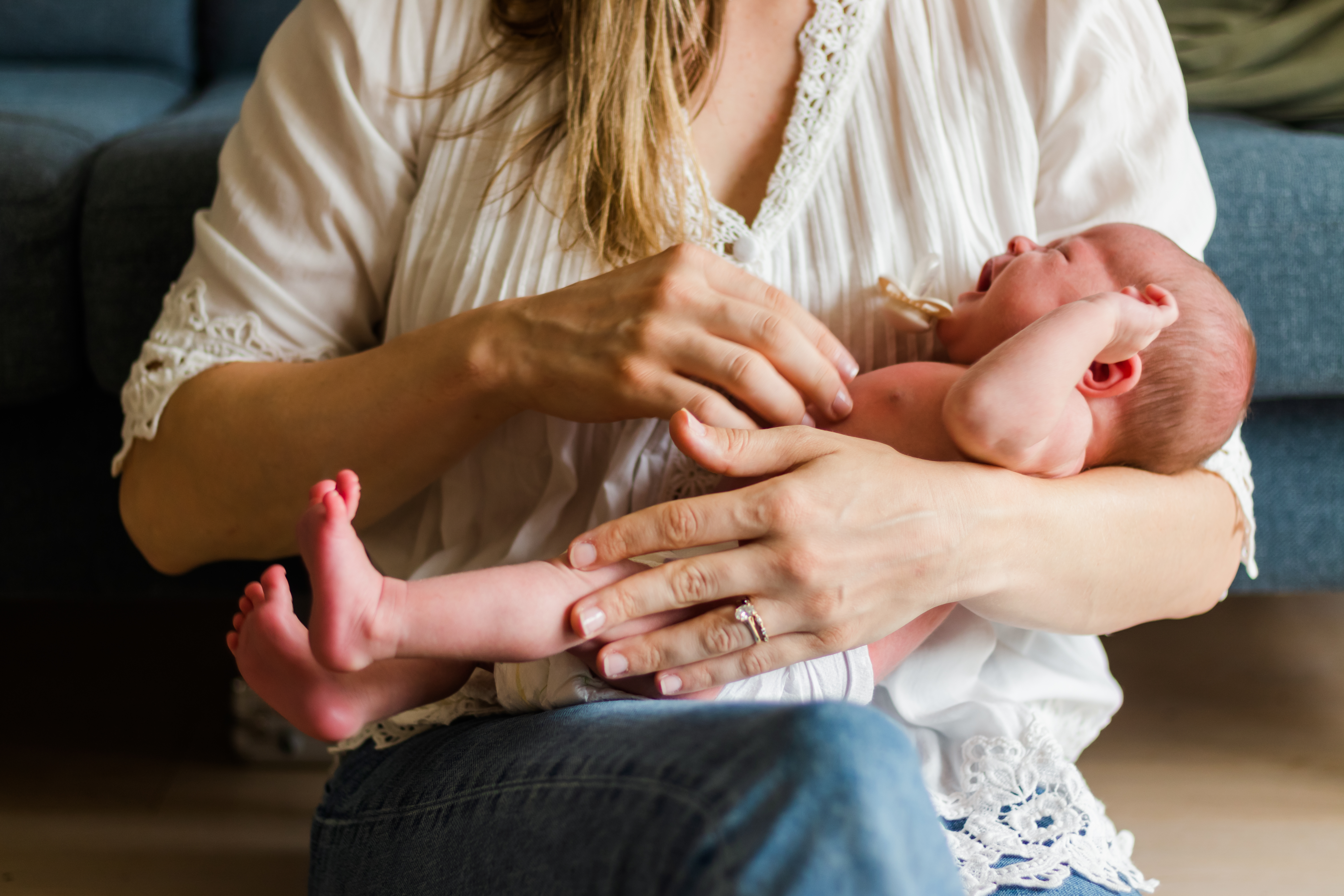 Mom wearing lace holding crying infant, photo foc